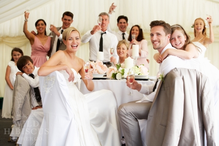 Bride And Groom Celebrating With Guests At Reception
